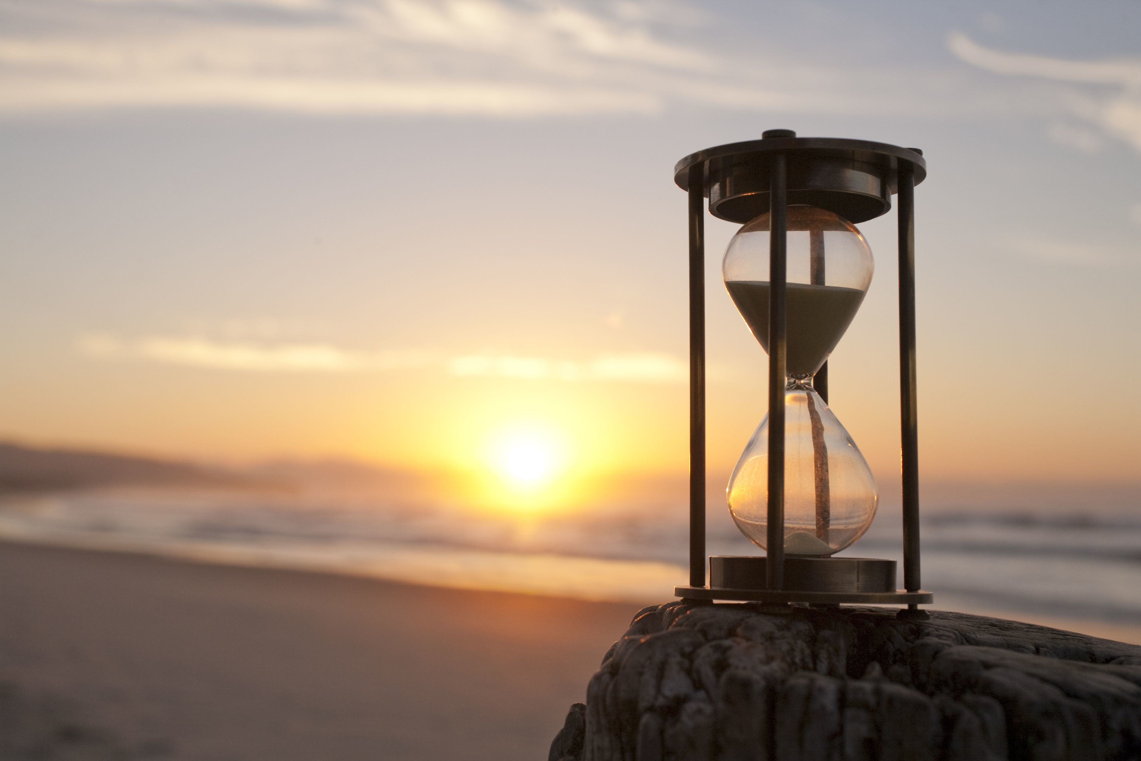Premium AI Image  Hourglass with Glowing Sand Background Wallpaper