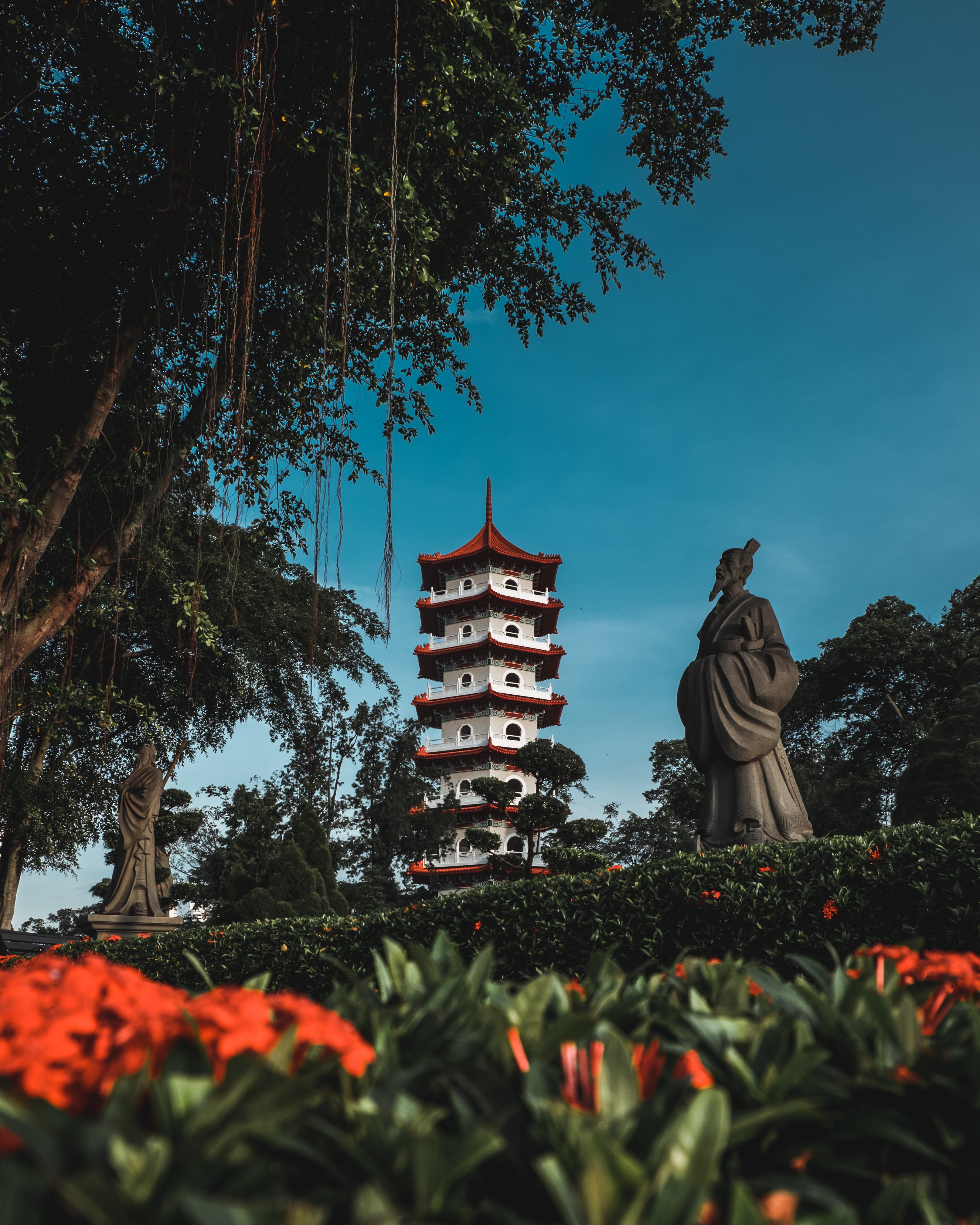Download mobile wallpaper Bush, Miscellanea, Miscellaneous, Trees, Building, Flowers, Pagoda, Statue for free.