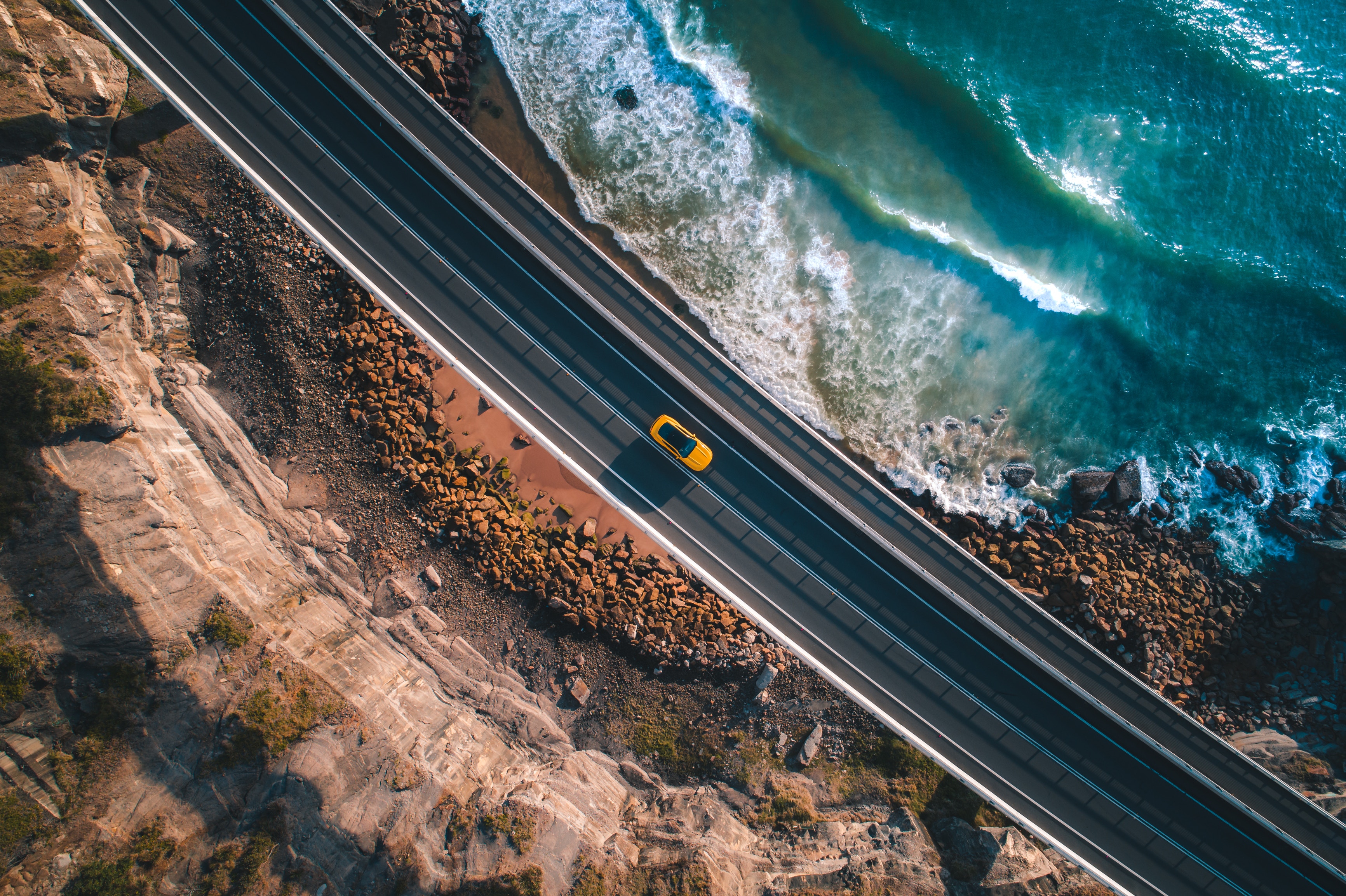 Download mobile wallpaper Coast, Road, Car, Wave, Photography, Highway, Aerial, Yellow Car for free.