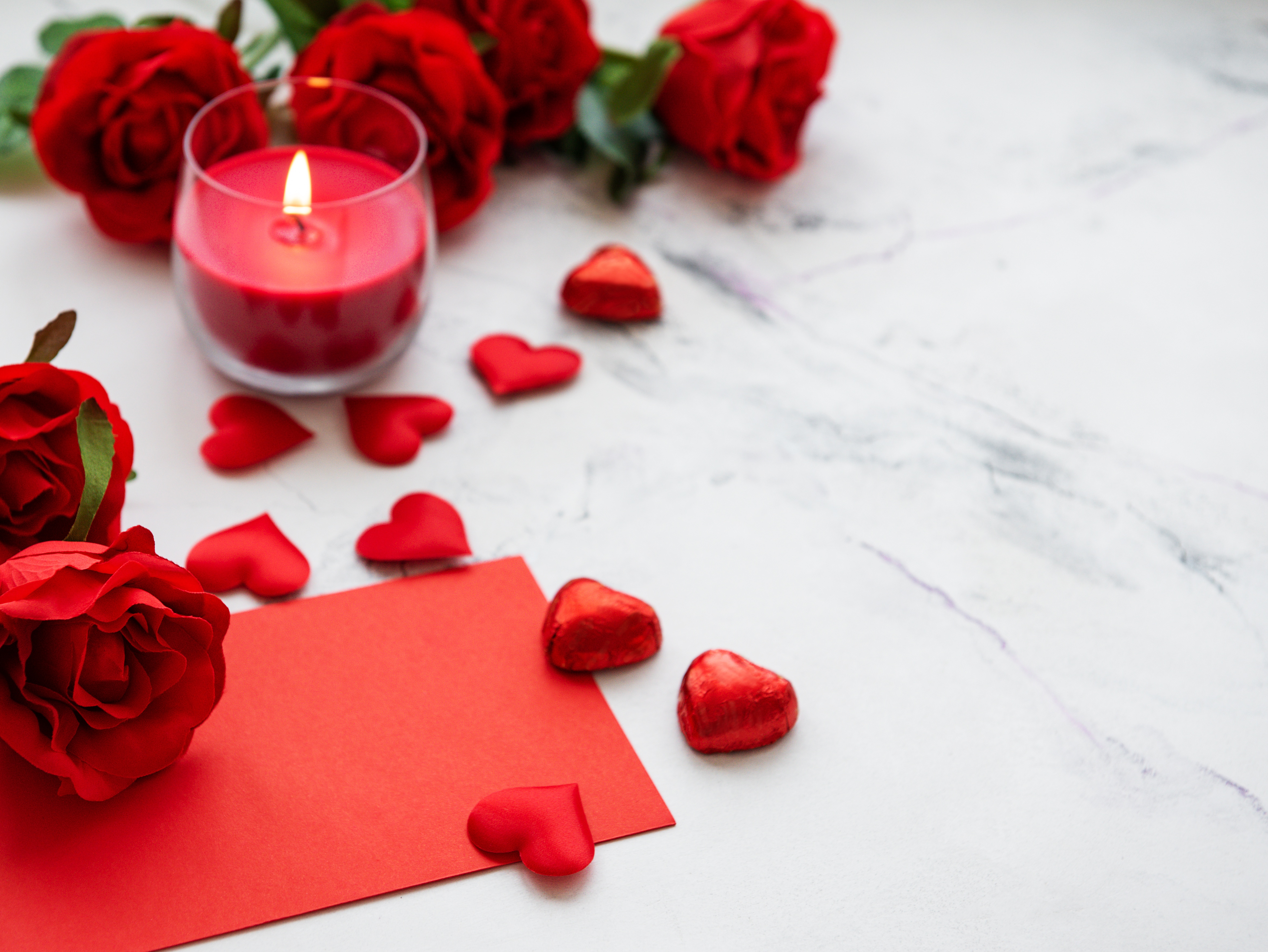 Beautiful romantic red candle with flowers, close up Stock Photo | Adobe  Stock