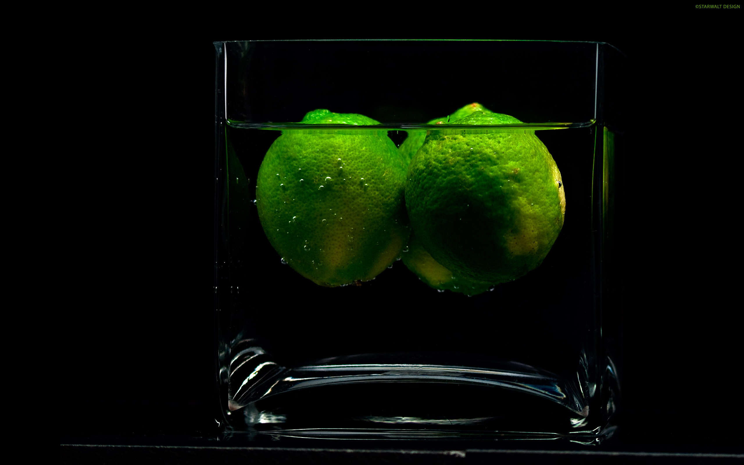 Зеленый лимон на черном фоне