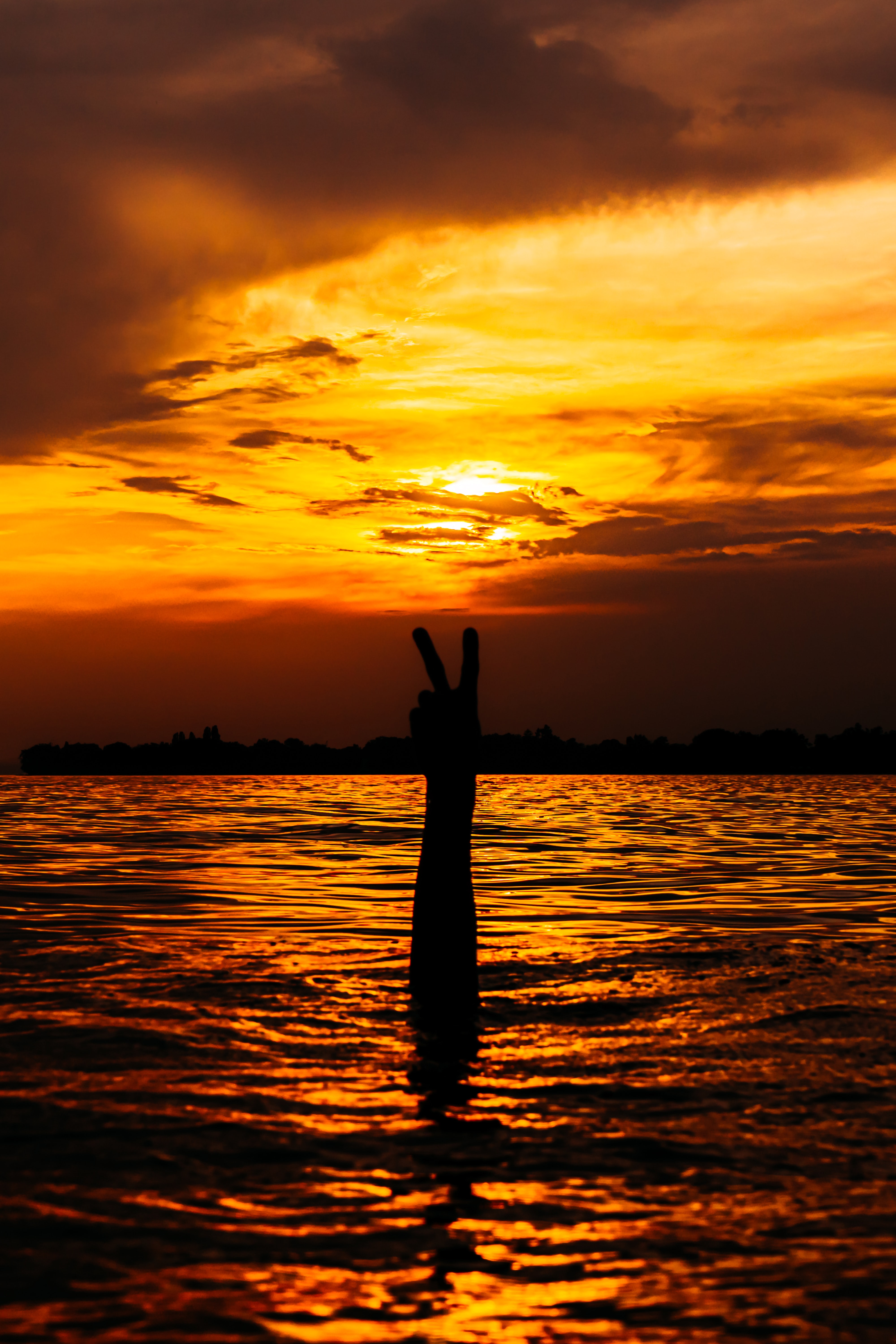 water, sunset, glare, hand, miscellanea, miscellaneous, gesture Image for desktop