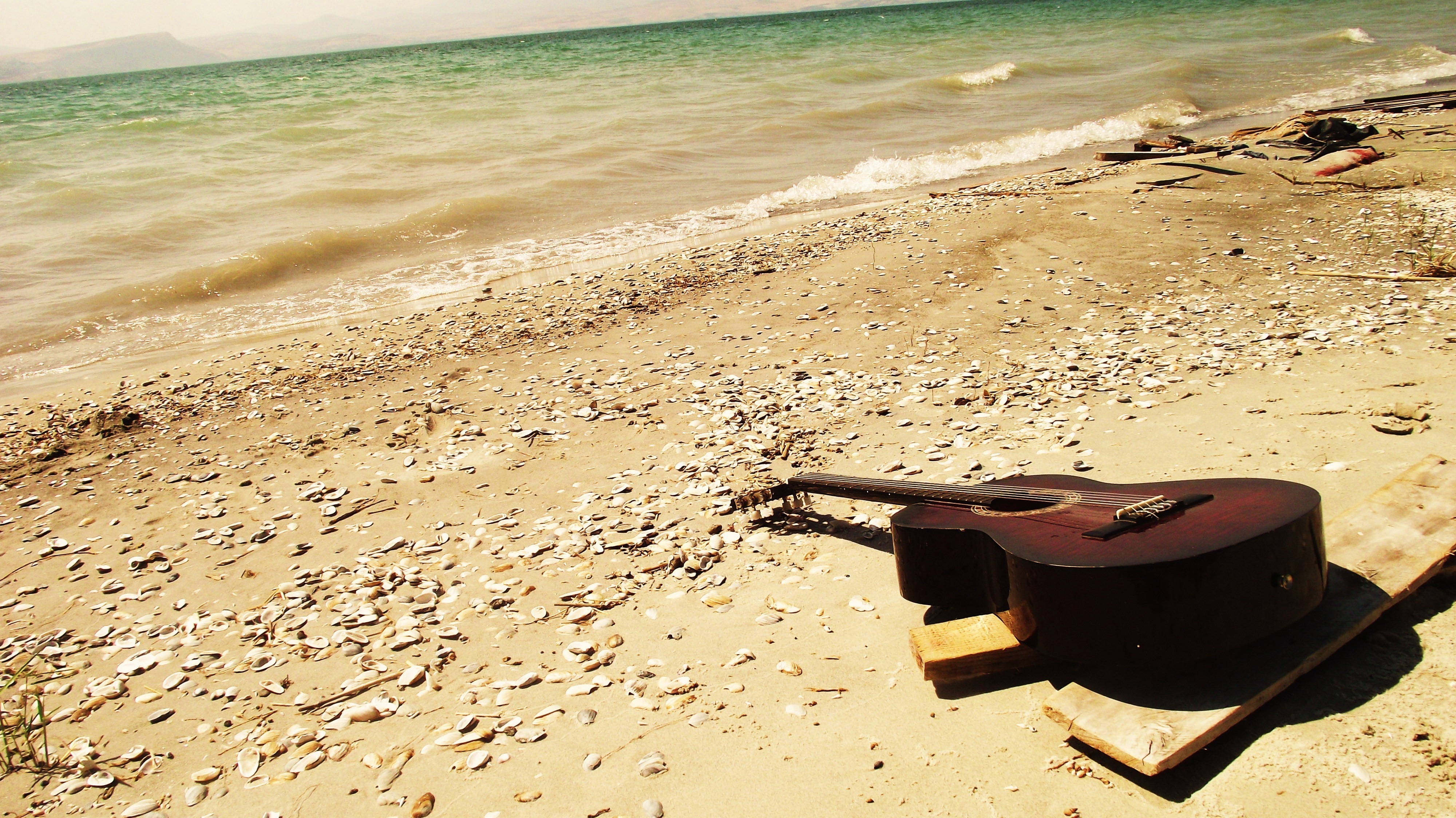 Free download wallpaper Guitar, Bank, Nature, Stones, Shore, Sand, Romance, Beach on your PC desktop