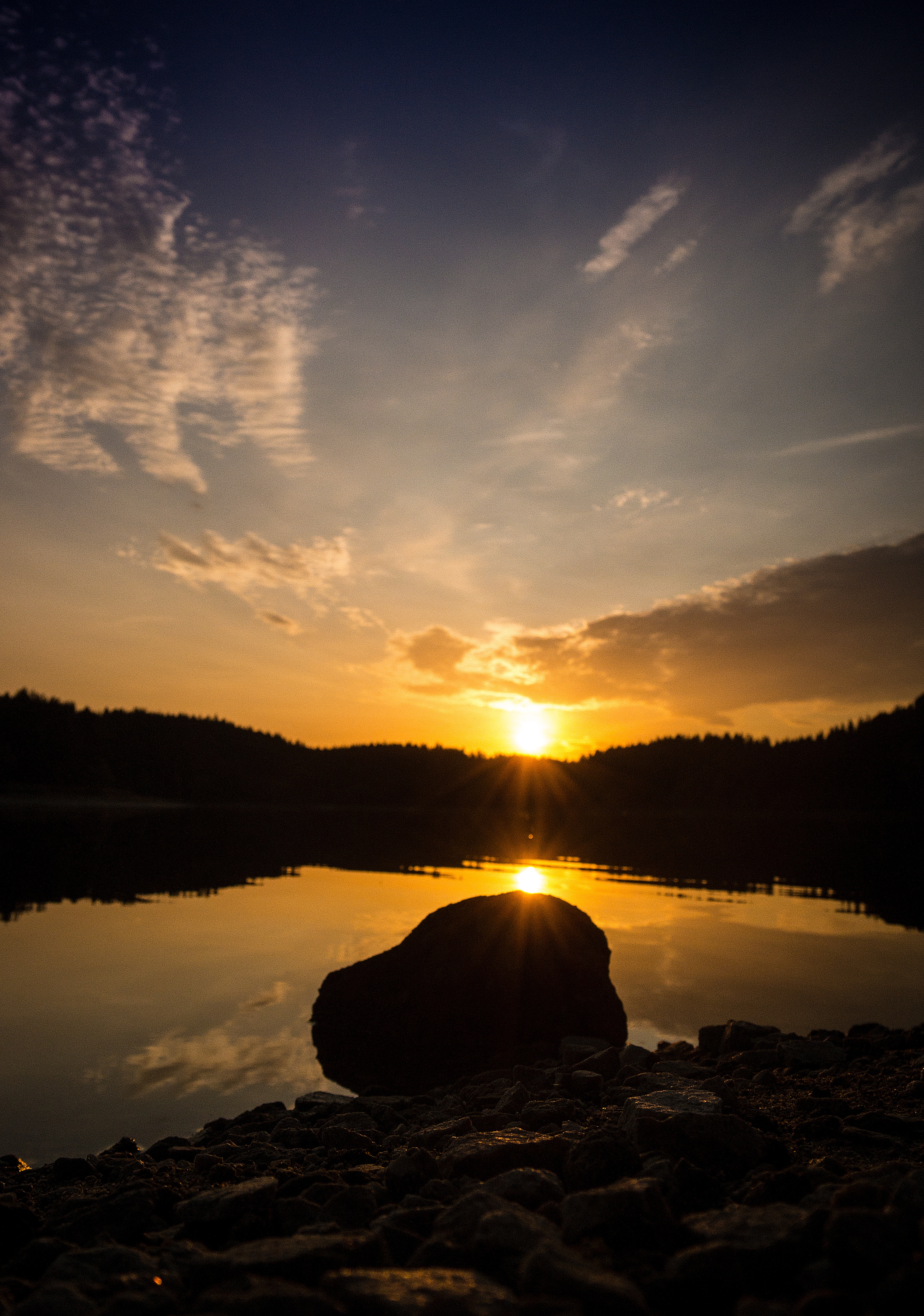 stone, nature, sunset, sky, sun, rock, lake, reflection, shore, bank, forest Image for desktop