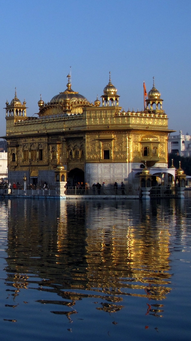 Download Golden Temple With Floating Candles Wallpaper | Wallpapers.com