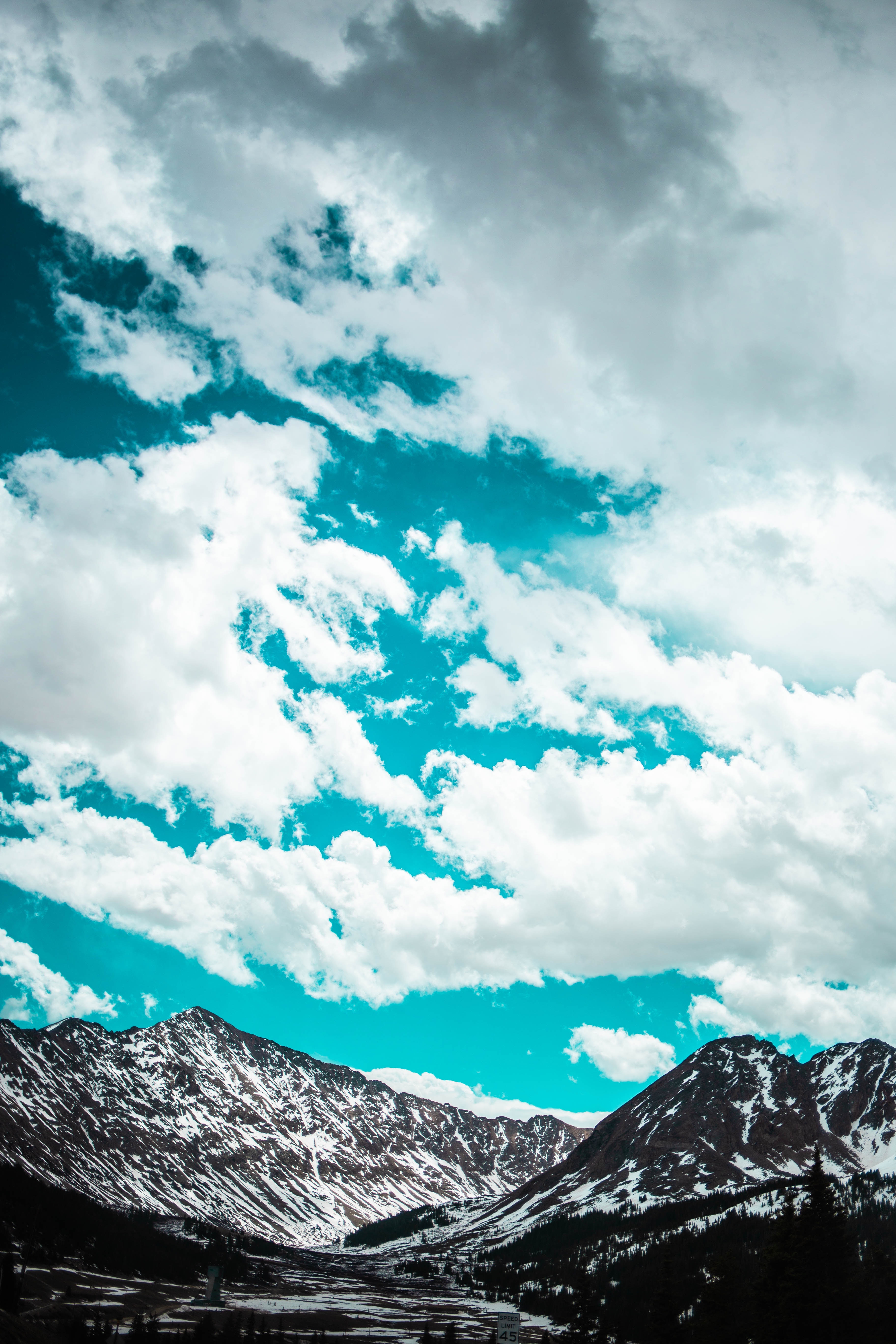 Download mobile wallpaper Porous, Clouds, Snow Covered, Nature, Mountains, Snowbound, Sky for free.
