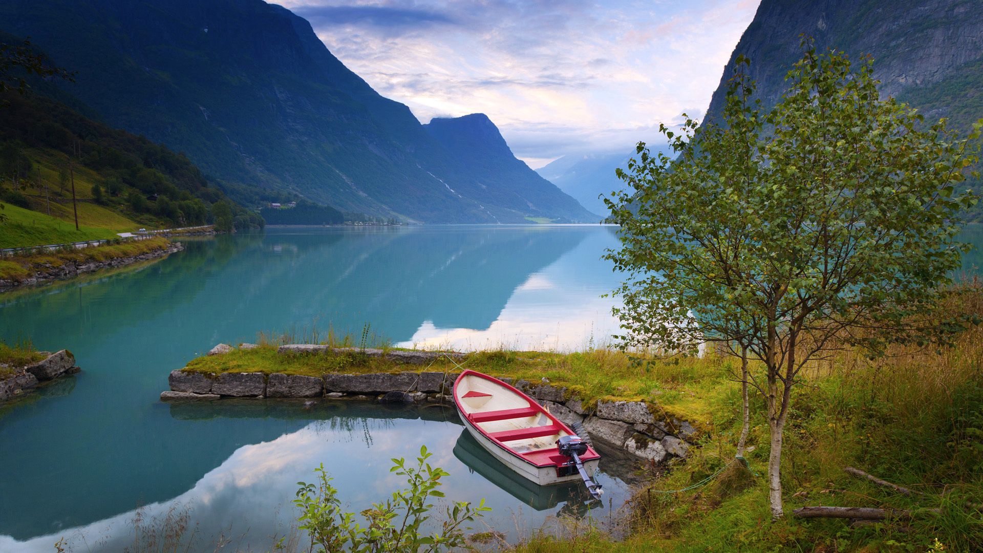 Mobile wallpaper lake, blue water, norway, boat, nature, grass, stones, mountains, shore, bank