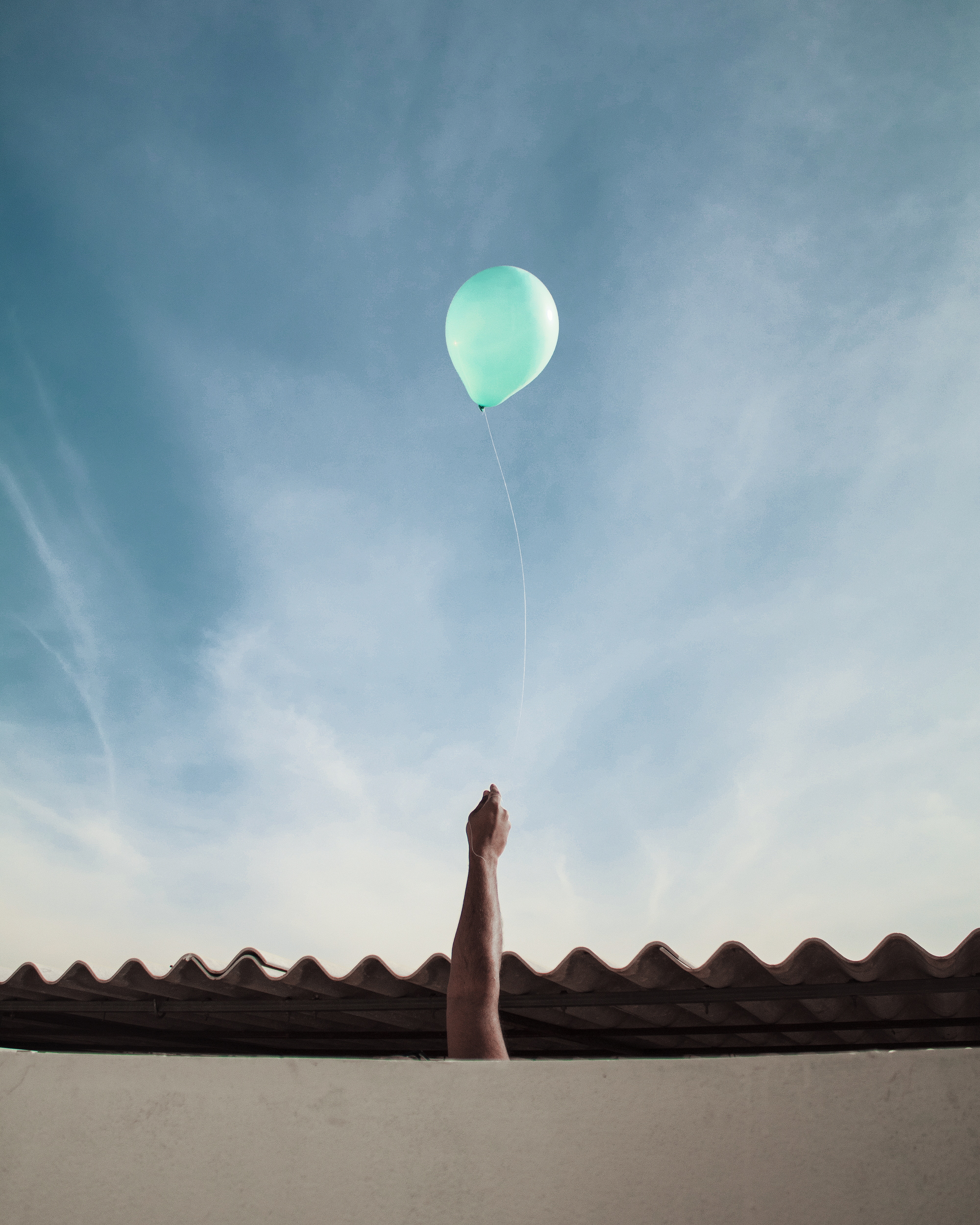 Free download wallpaper Sky, Balloon, Roof, Clouds, Miscellanea, Hand, Miscellaneous on your PC desktop