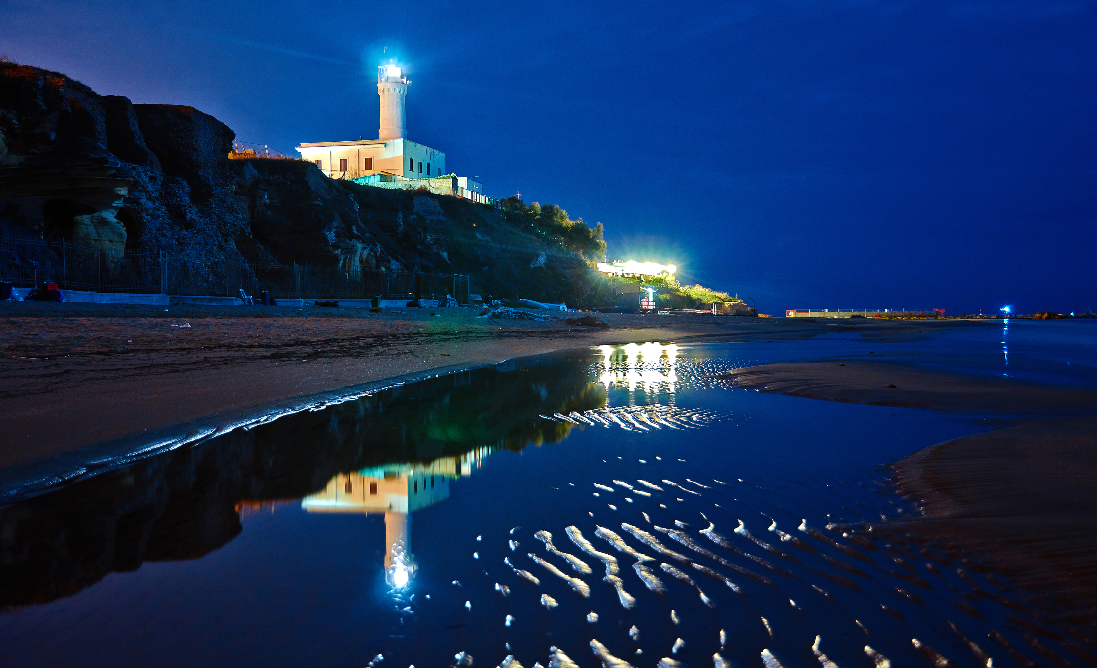 Download mobile wallpaper Sea, Night, Italy, Coast, Ocean, Lighthouse, Man Made for free.