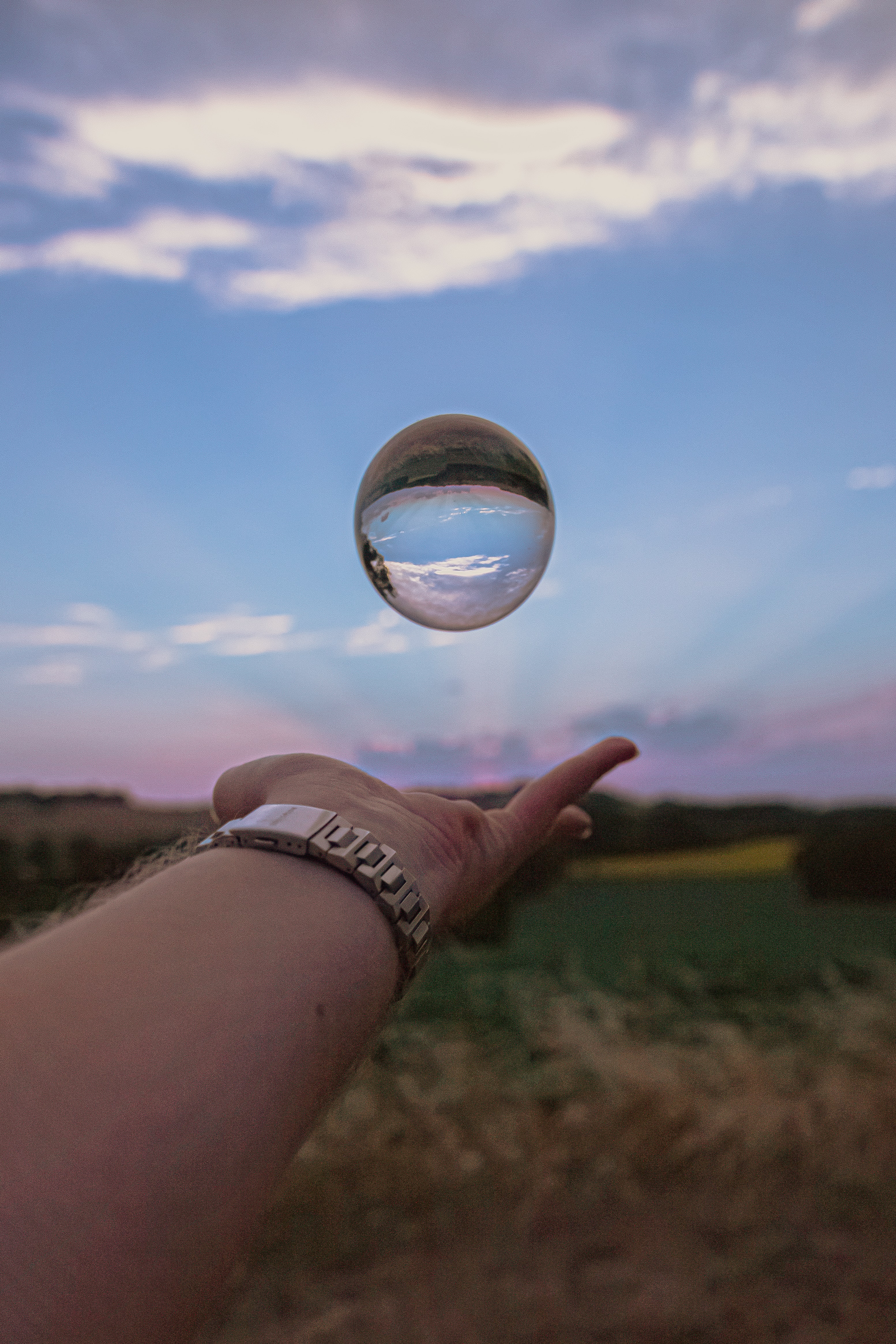 Download mobile wallpaper Reflection, Miscellaneous, Sky, Miscellanea, Hand, Ball, Clock for free.