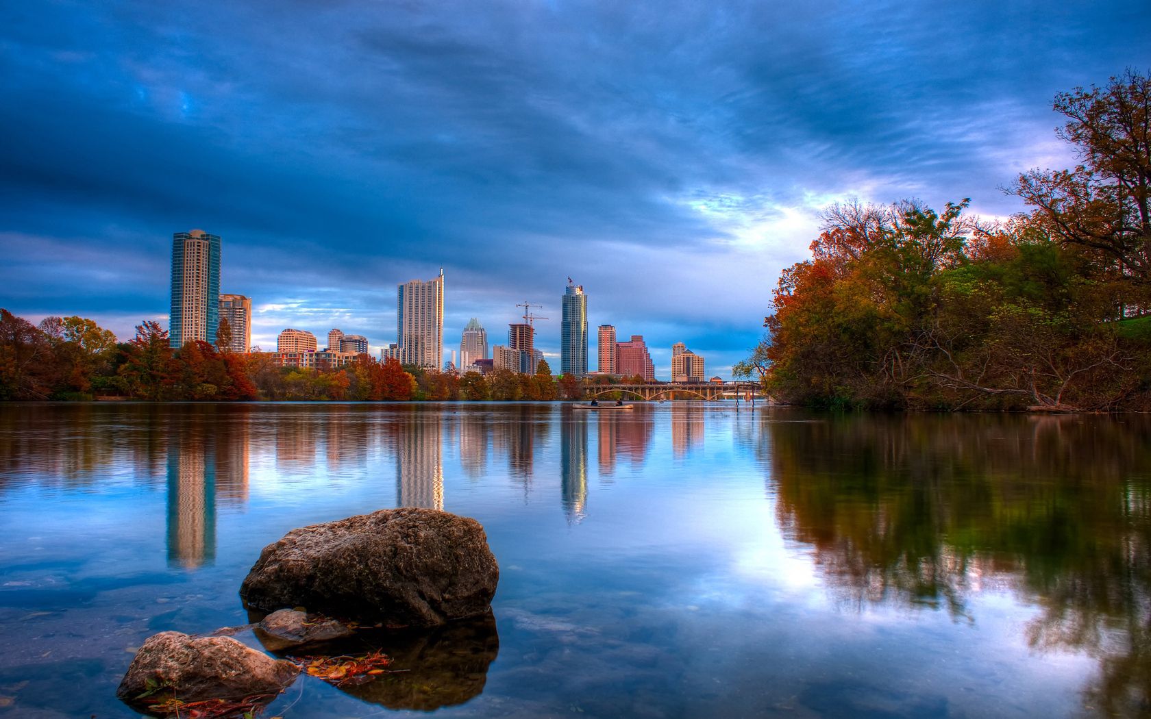 Download mobile wallpaper Reflection, Shore, Austin, Bank, Cities, Rivers, Trees, Stones, Texas for free.