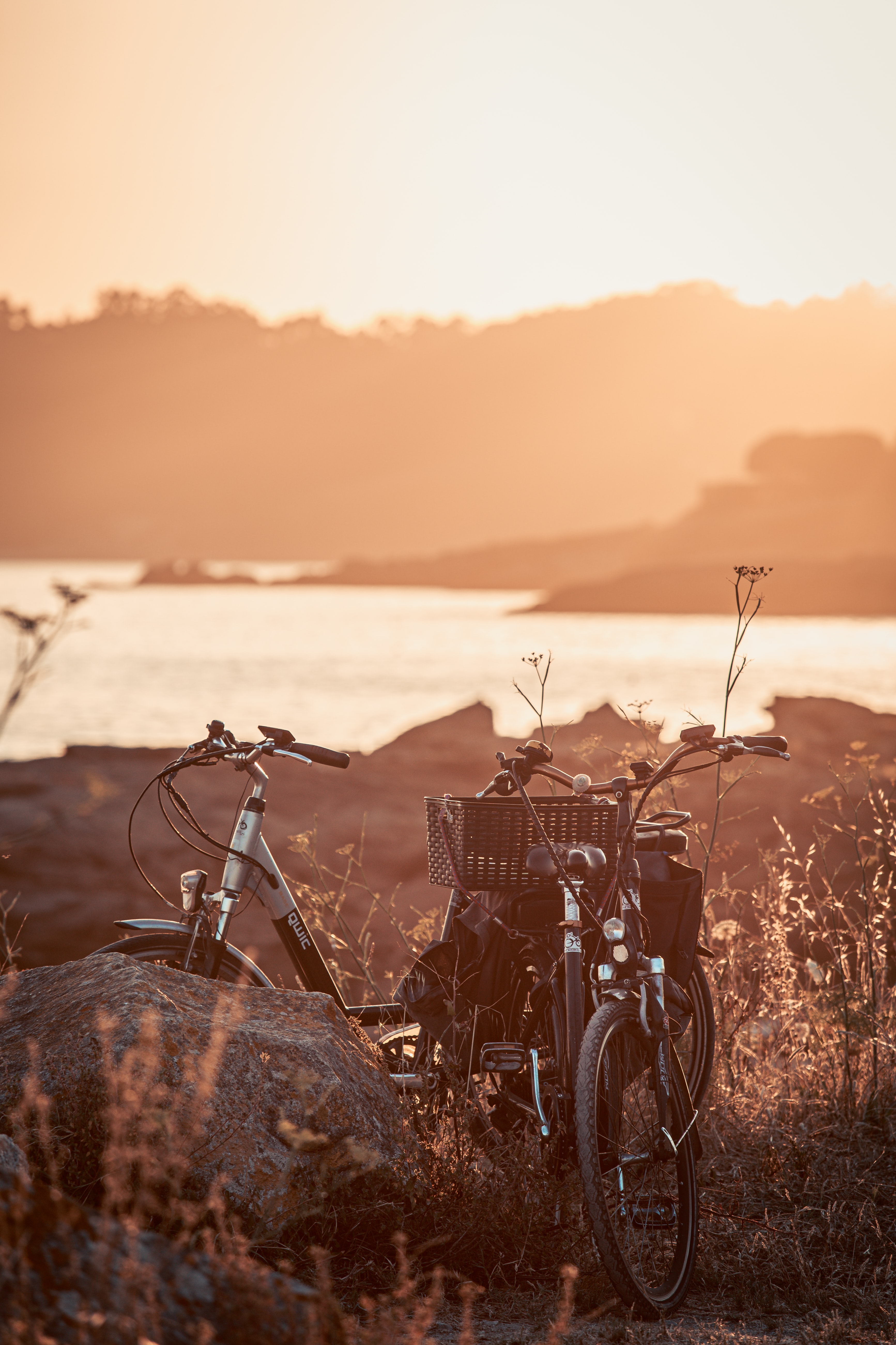 Download mobile wallpaper Lake, Miscellaneous, Rock, Stone, Stroll, Sunset, Miscellanea, Bicycle for free.