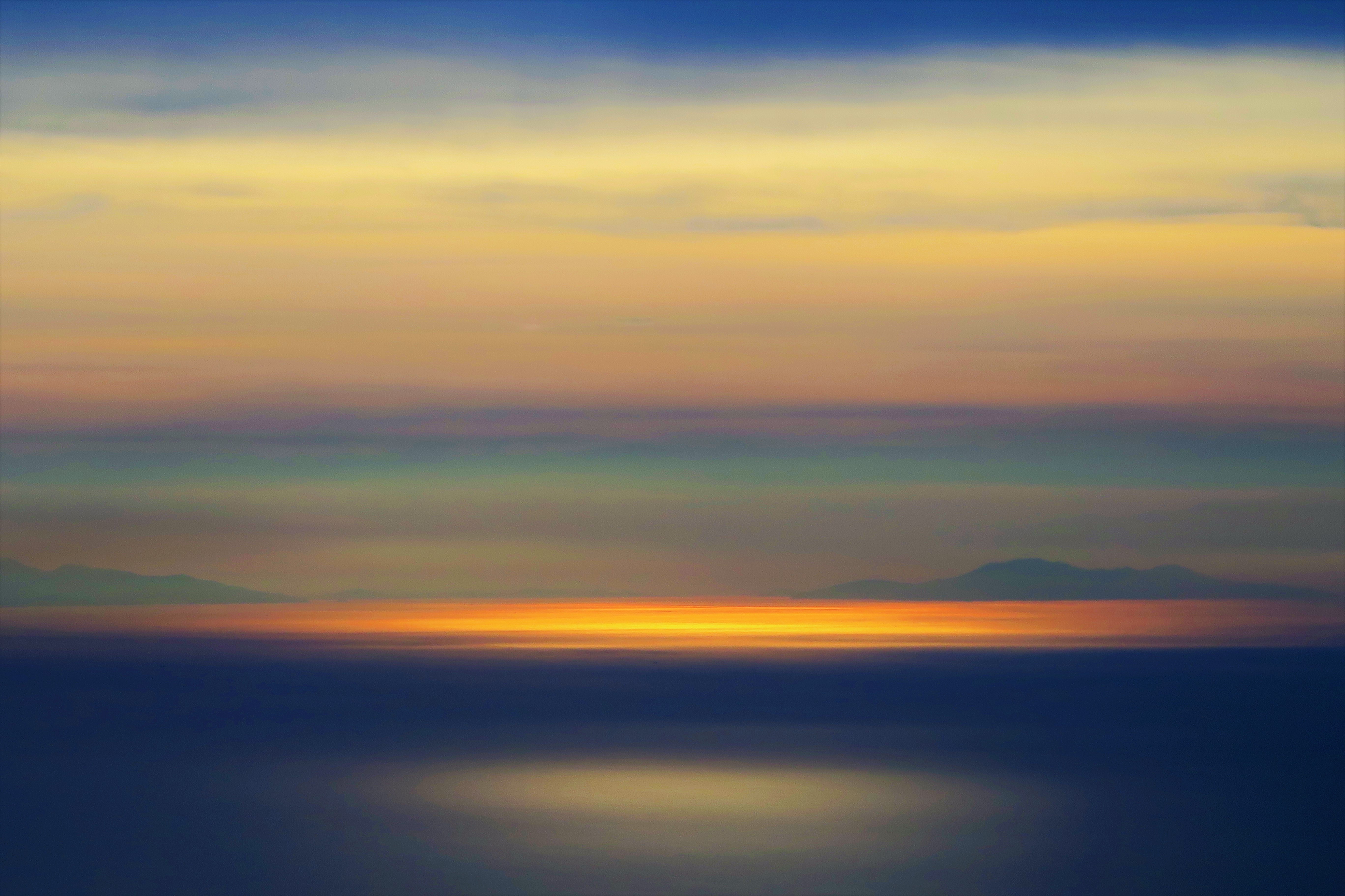 nature, water, sunset, horizon, glare, blur, smooth, surface, gleam 1080p