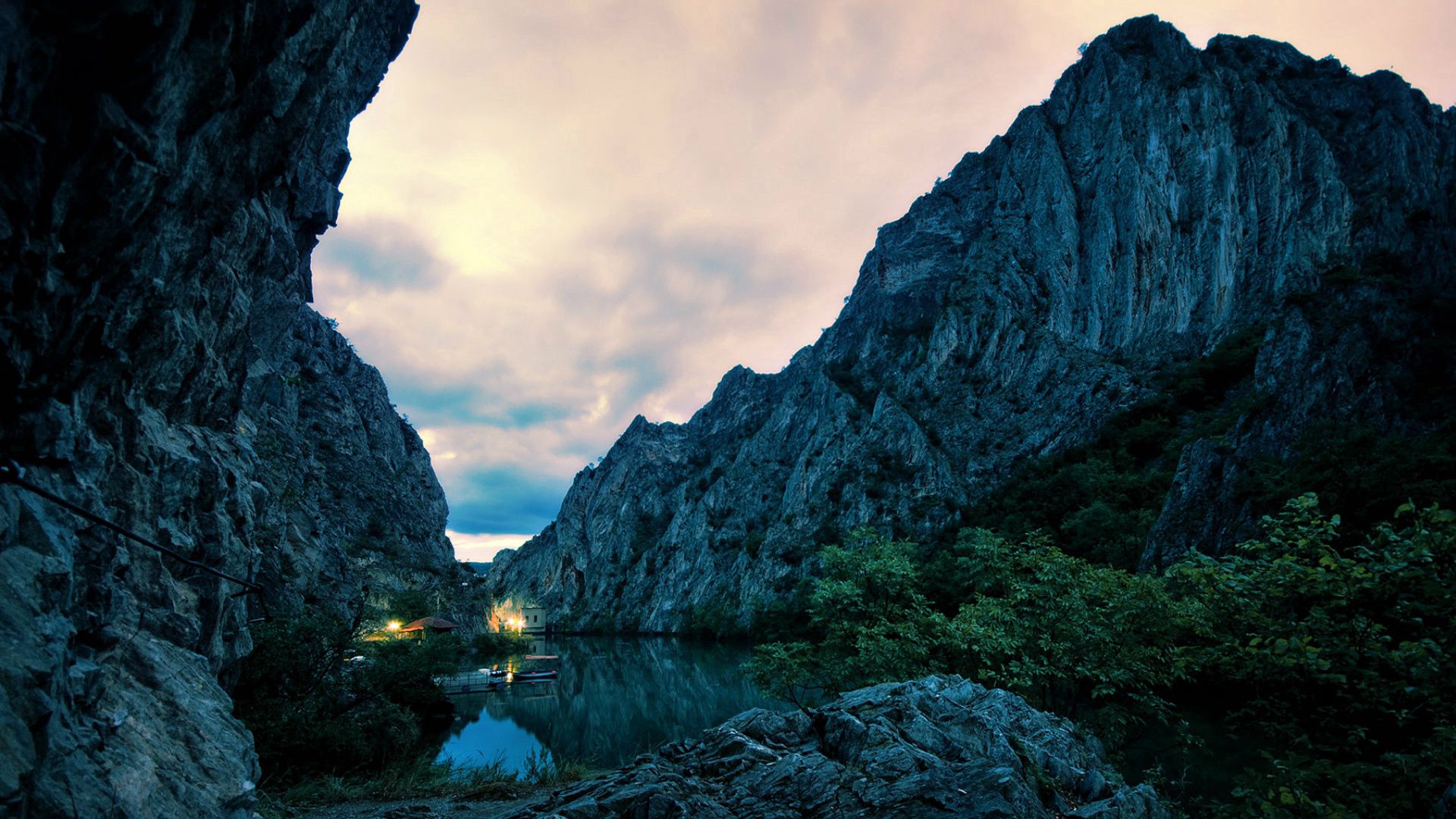 house, nature, mountains, twilight, bush, lights, rocks, lake, dusk, evening, cliffs Image for desktop