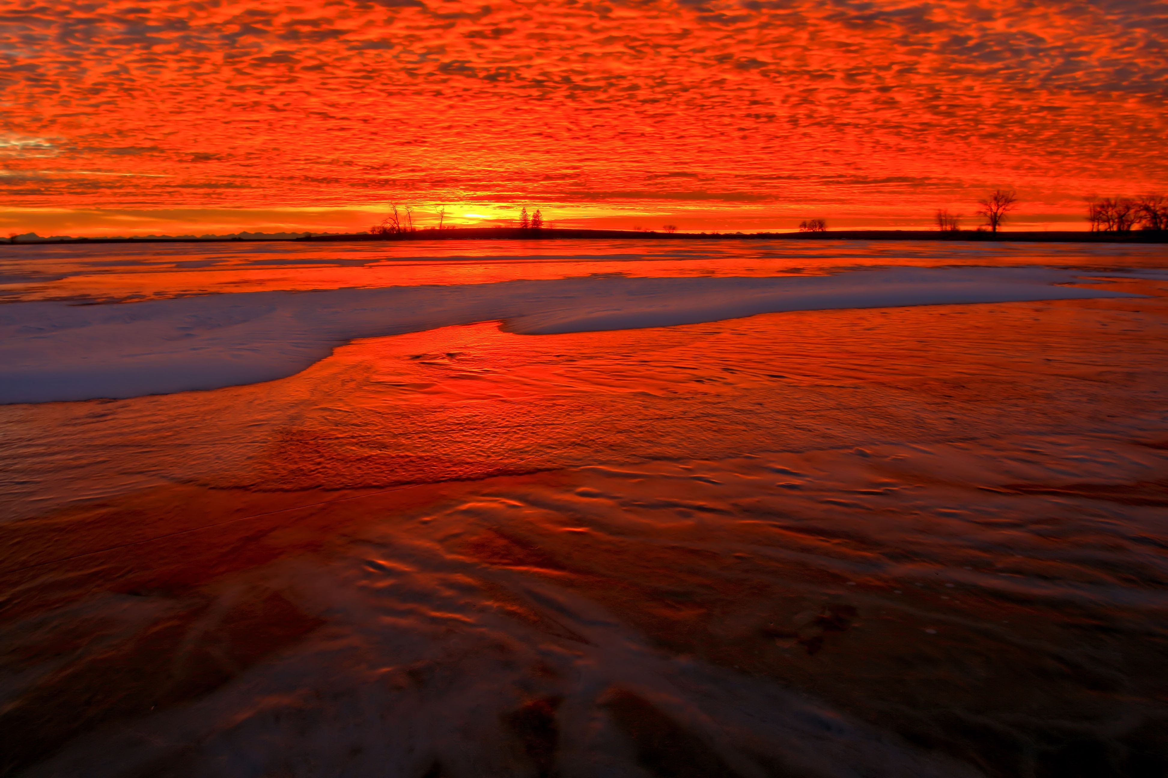 Download mobile wallpaper Shore, Bank, Fiery, Snow, Horizon, Nature, Sunset for free.