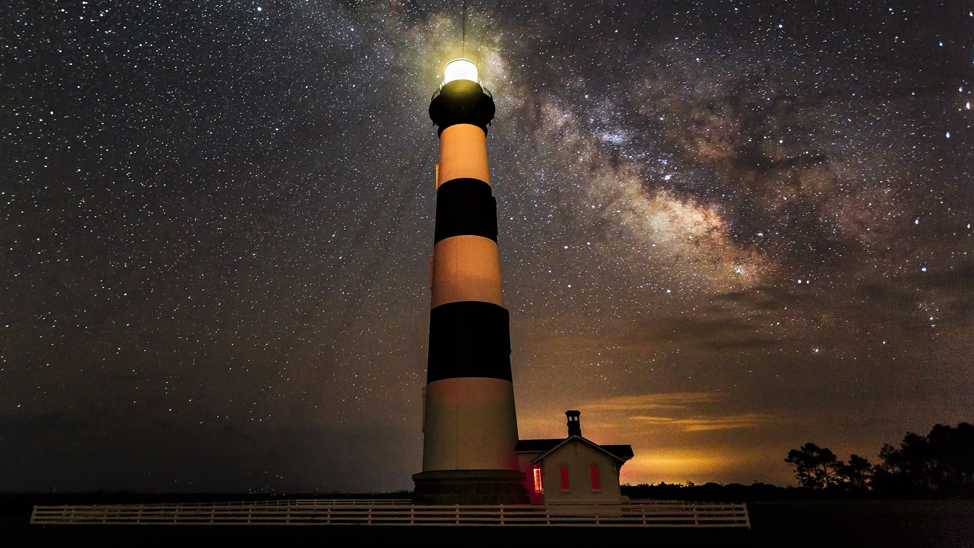 Download mobile wallpaper Sky, Stars, Night, Light, Starry Sky, Milky Way, Lighthouse, Man Made, Bodie Island Lighthouse for free.