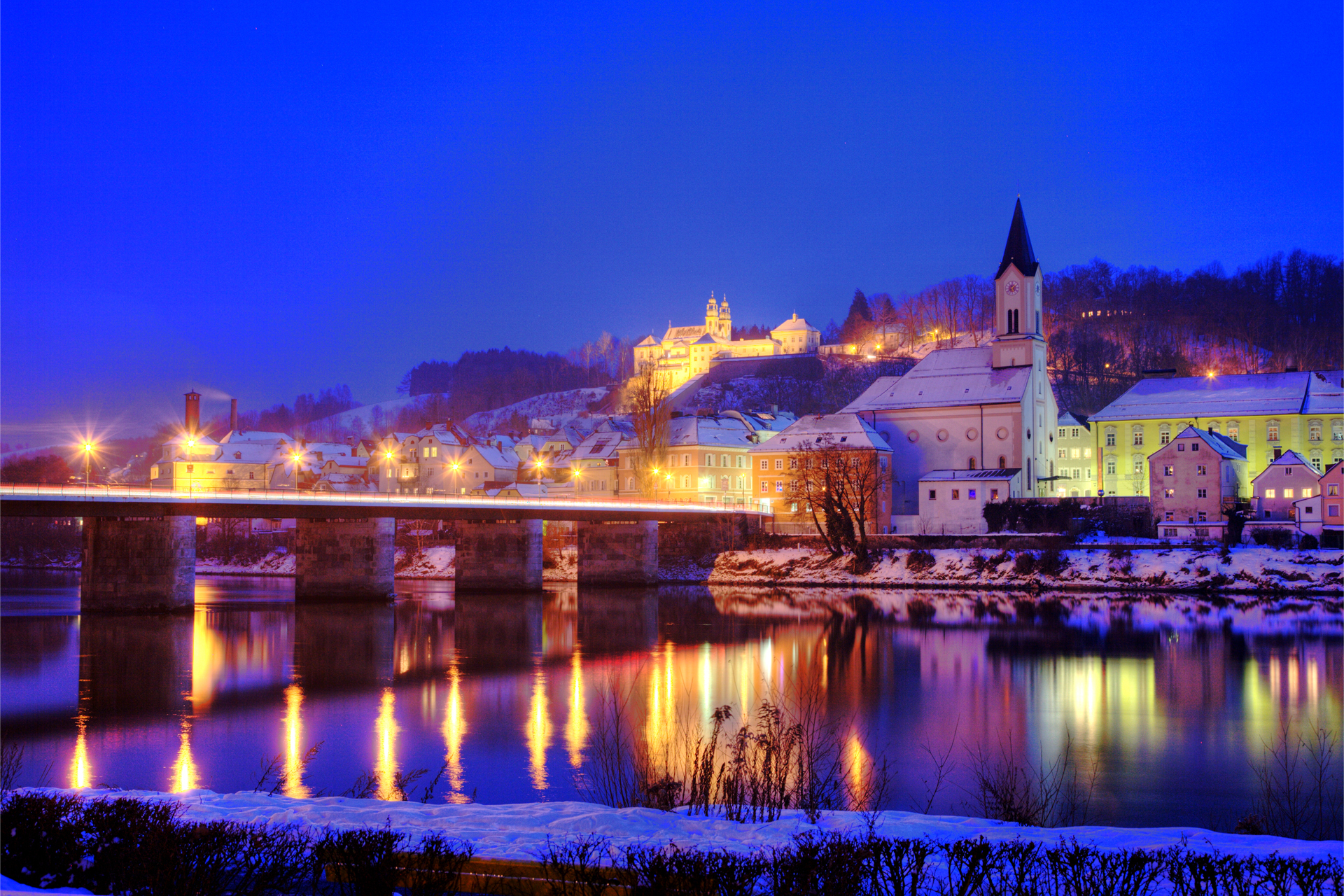 Download mobile wallpaper Germany, Evening, River, Towns, Bridge, Town, Light, Man Made, City for free.