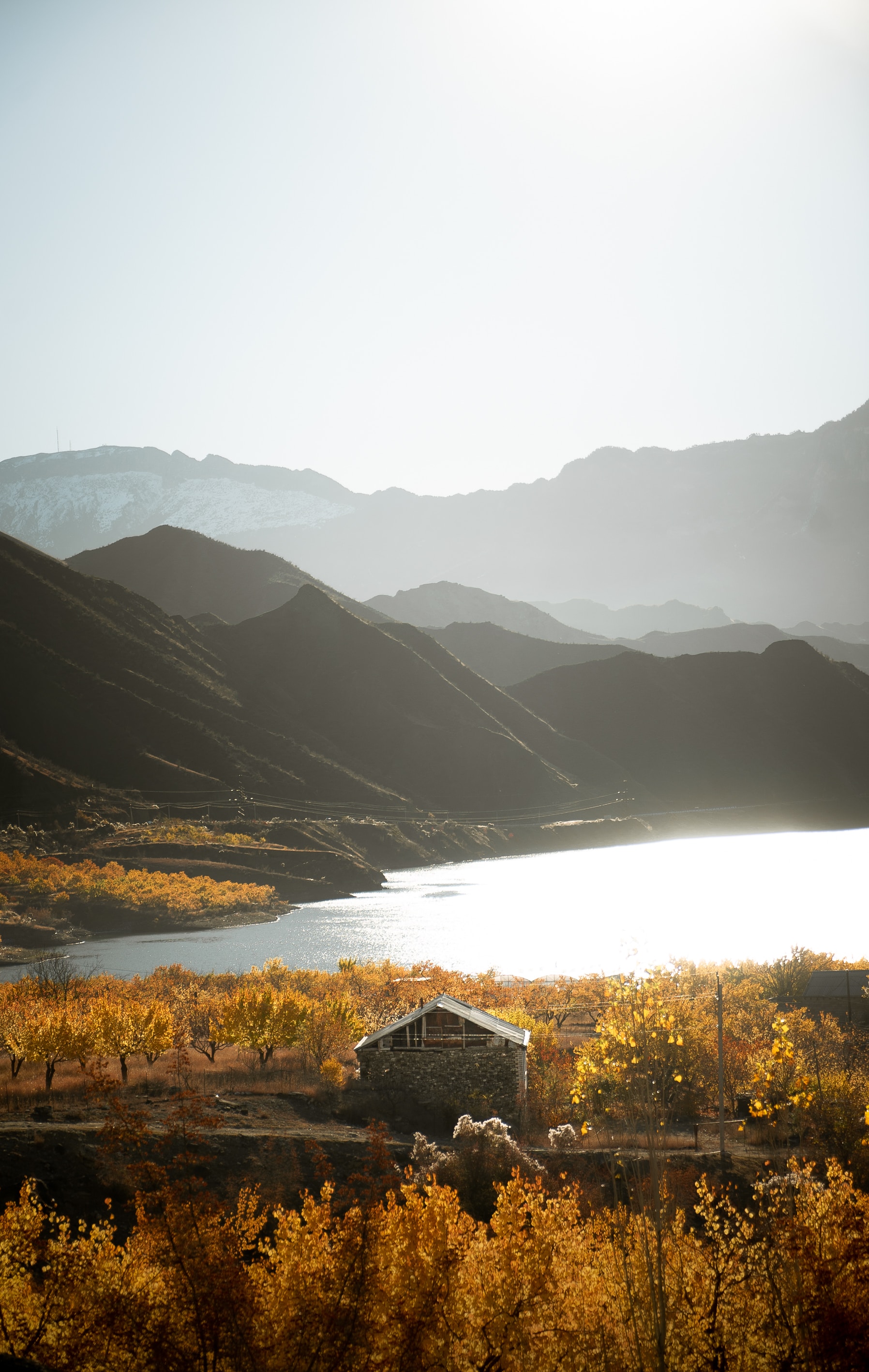 Download mobile wallpaper Bank, Shore, Lodge, Nature, Lake, Small House, Mountains for free.