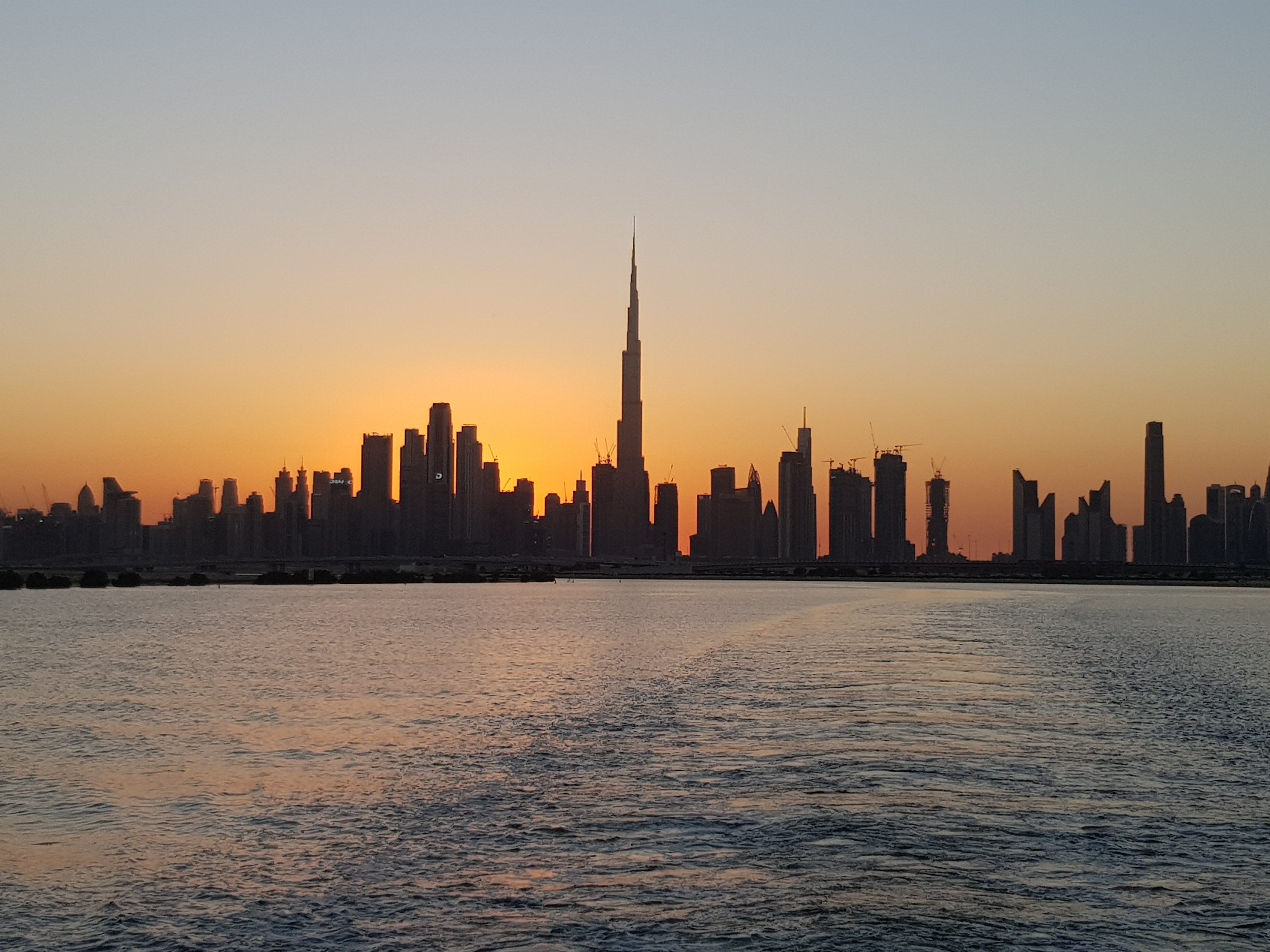 Download mobile wallpaper Dubai, City, Building, Uae, U A E, Coast, Cities, Sunset for free.