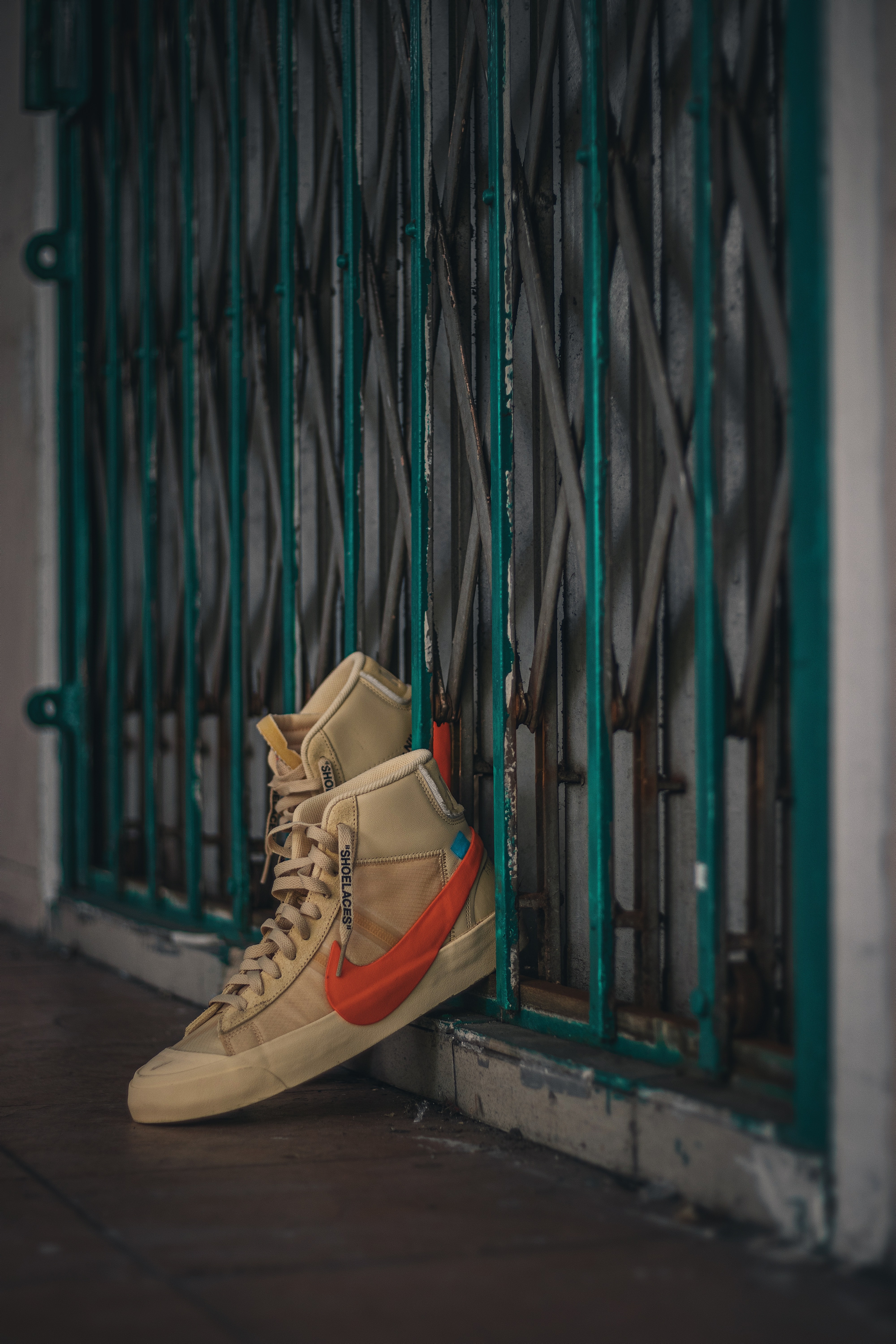 Download mobile wallpaper Fence, Miscellaneous, Footwear, Miscellanea, Sneakers for free.