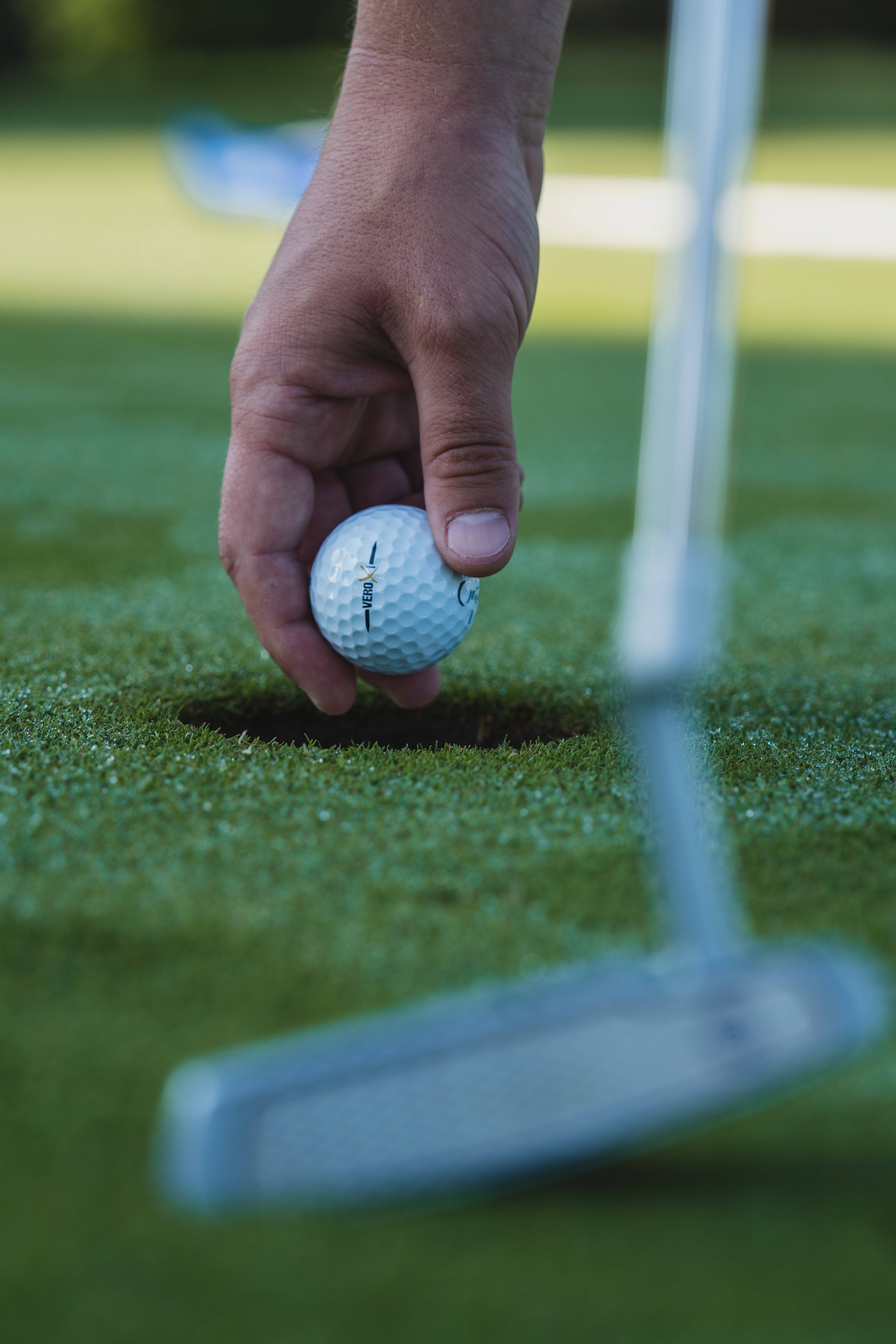 Download mobile wallpaper Grass, Hand, Ball, Sports, Golf for free.