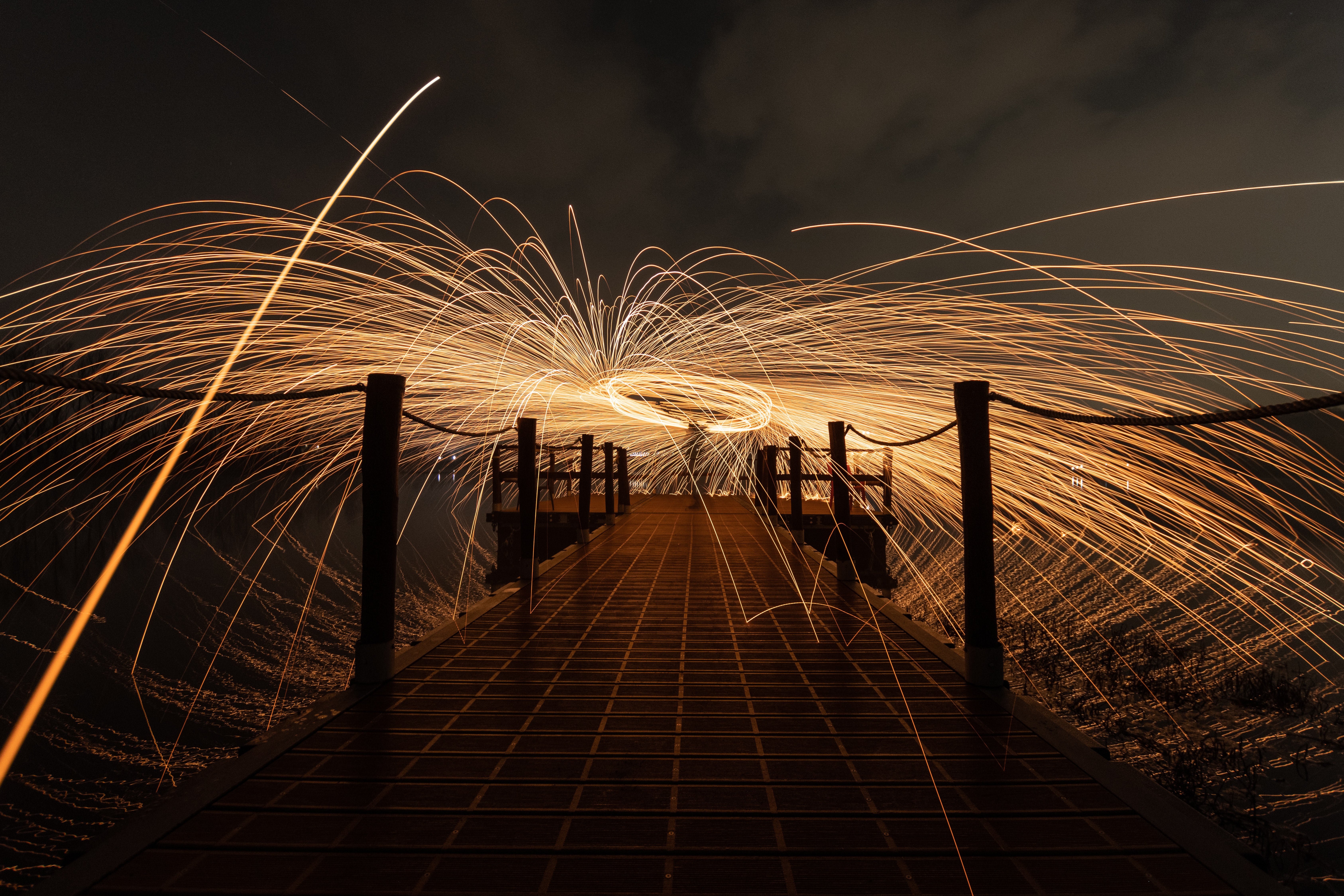 Download mobile wallpaper Freezelight, Sparks, Long Exposure, Miscellaneous, Miscellanea, Shine, Pier, Light for free.