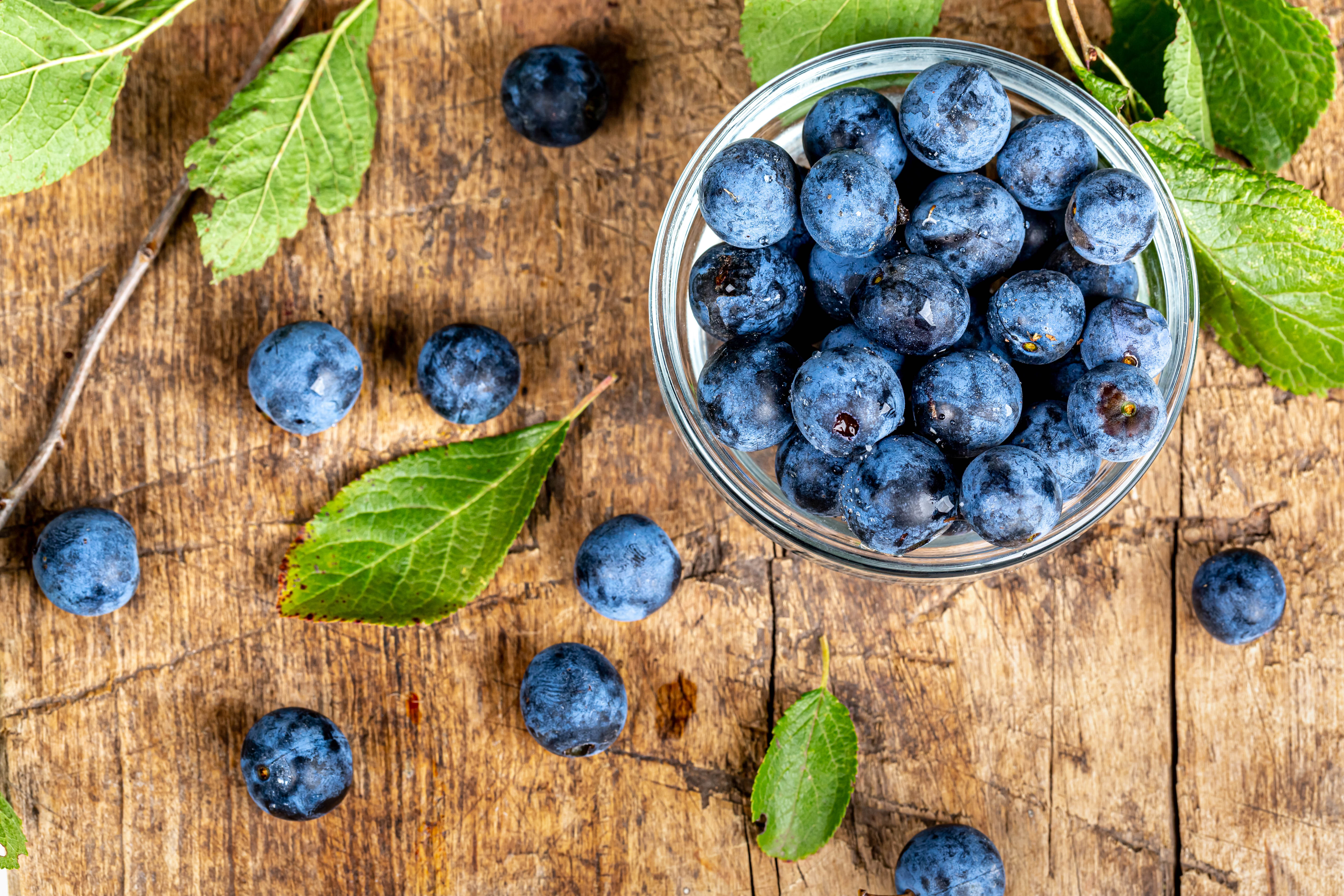 Download mobile wallpaper Bilberries, Leaves, Wood, Berry, Food, Fruit, Wooden for free.