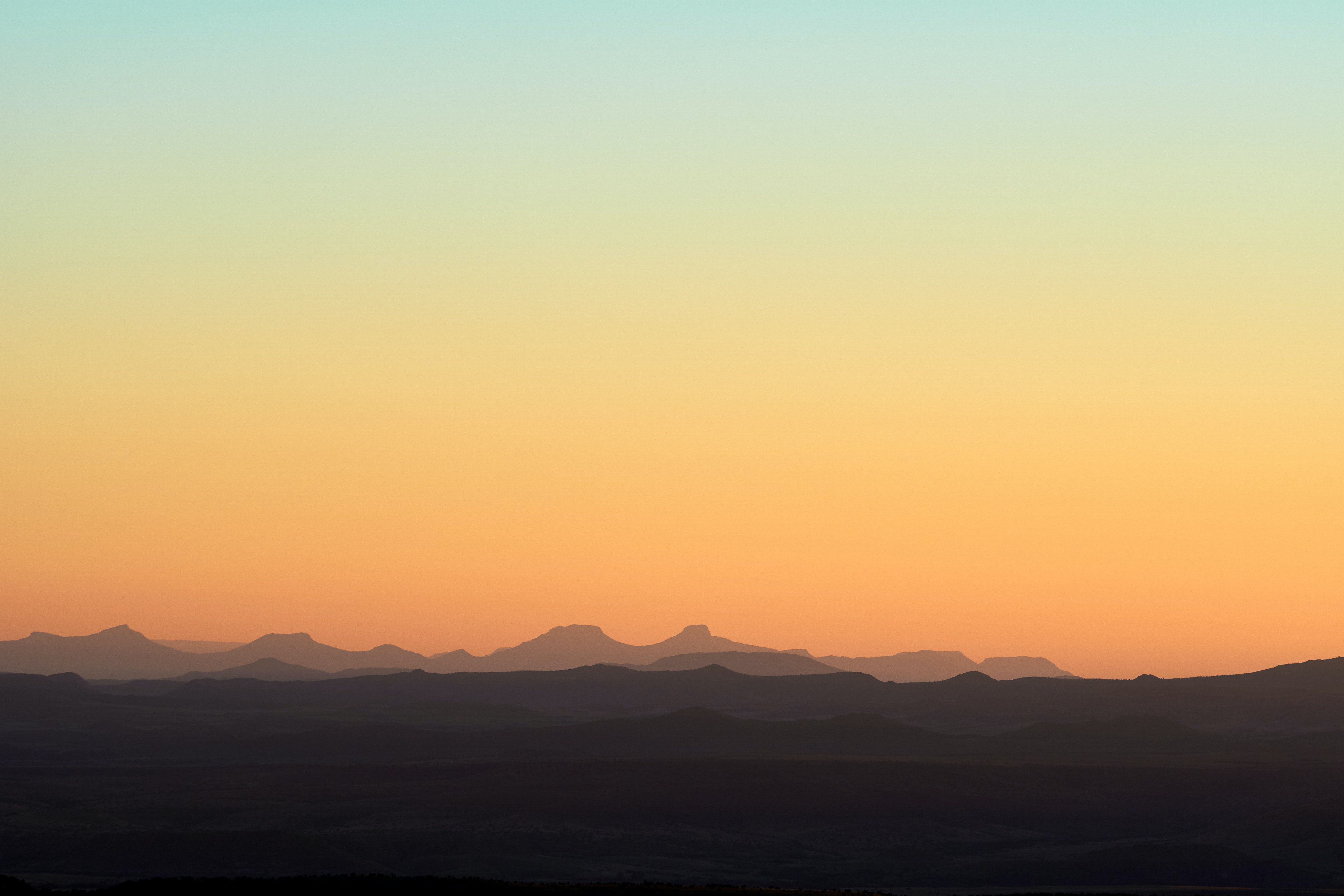 Download mobile wallpaper Hills, Distance, Sky, Dahl, Sunset, Mountains, Nature for free.