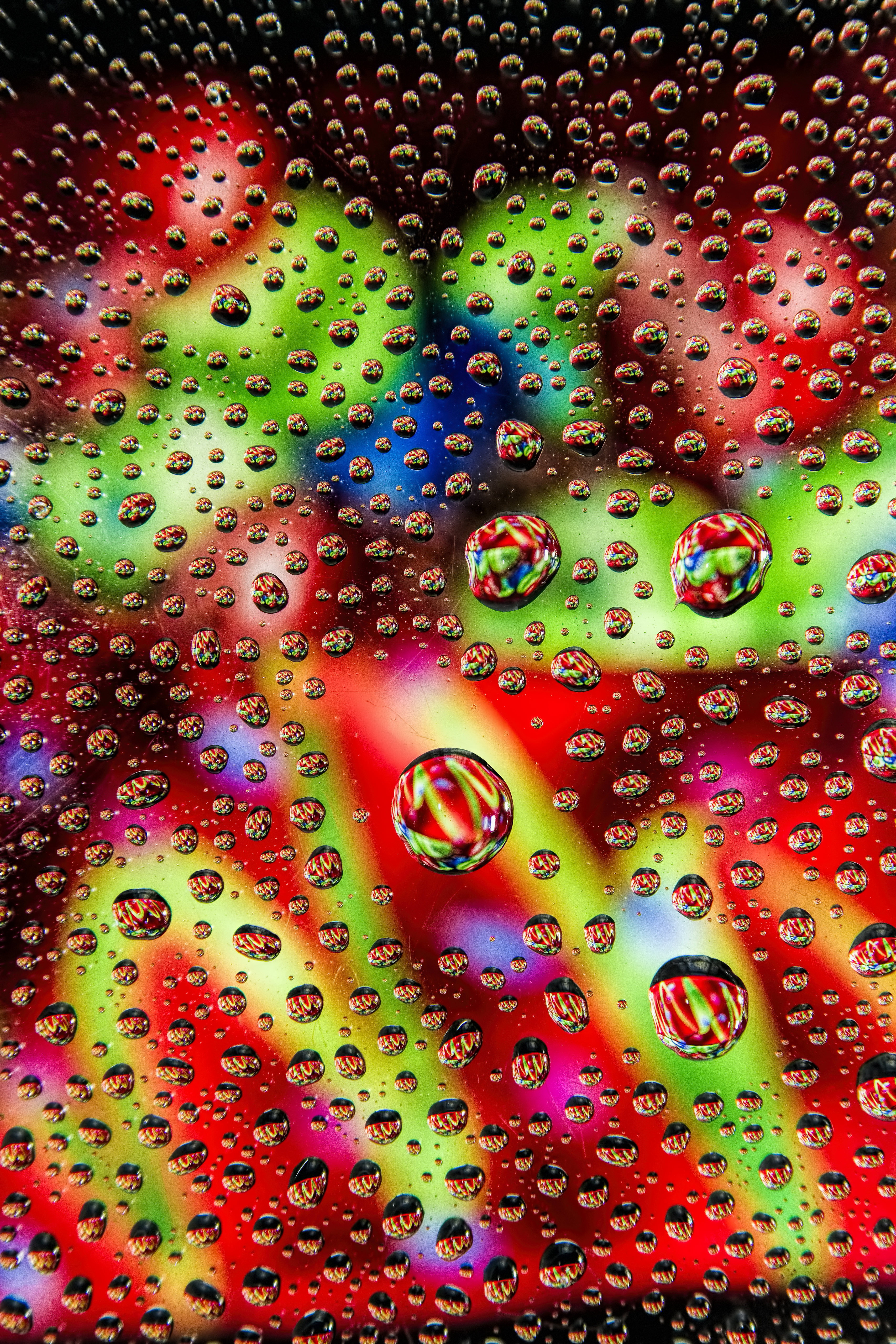 Download mobile wallpaper Reflection, Motley, Multicolored, Drops, Surface, Abstract for free.