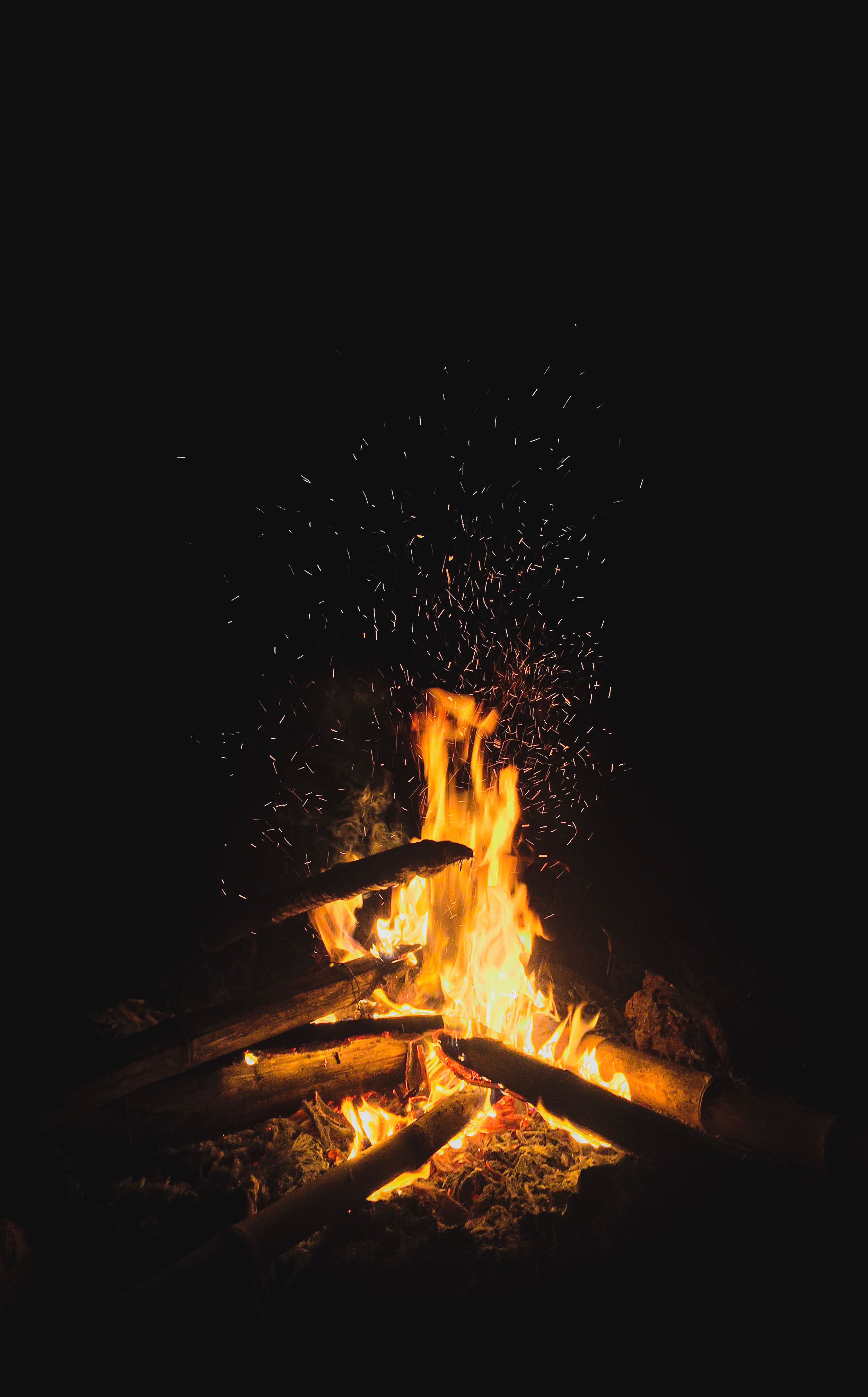 Download mobile wallpaper Sparks, Bonfire, Fire, Flame, Firewood, Dark for free.