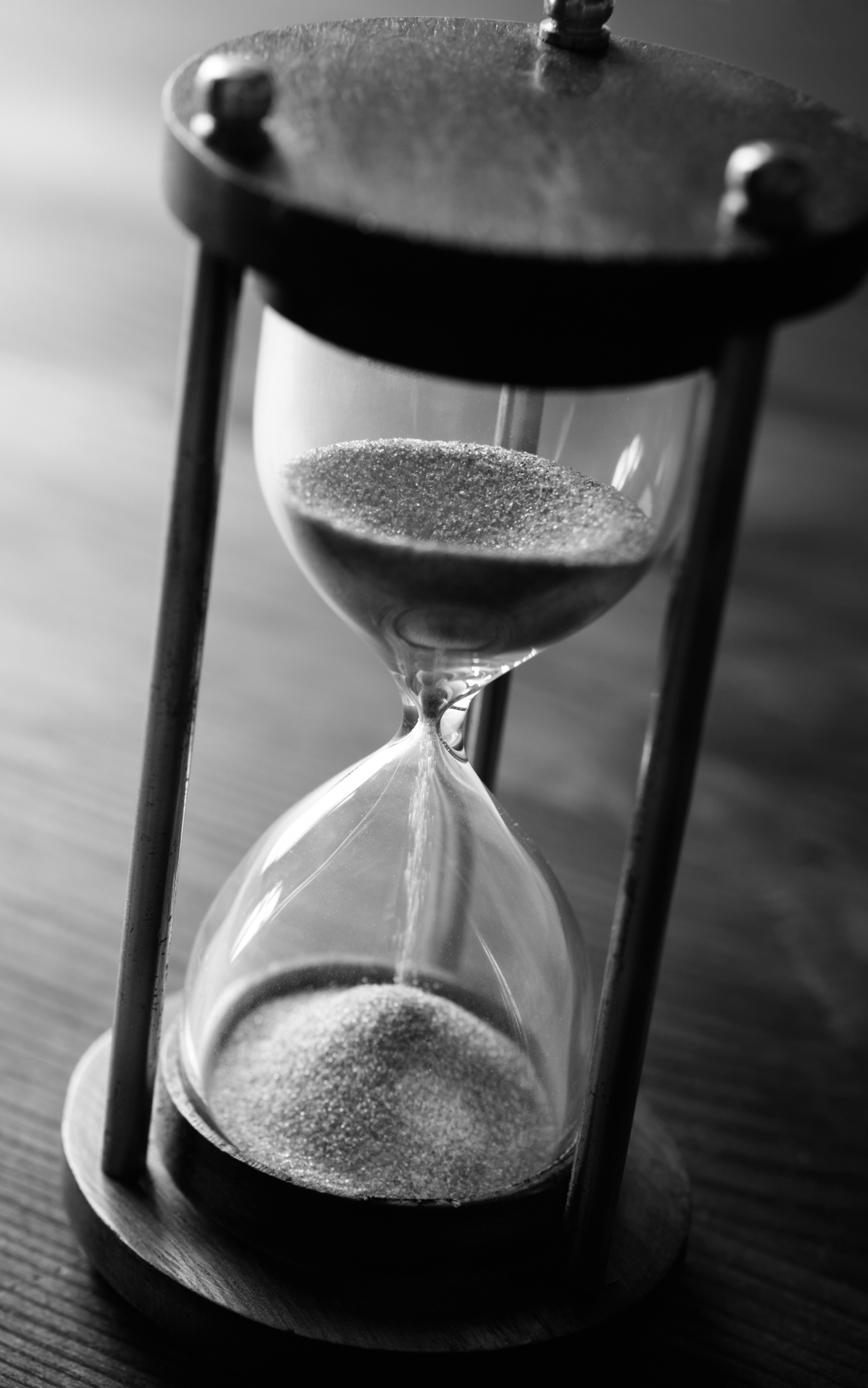 Premium AI Image  Hourglass with Glowing Sand Background Wallpaper